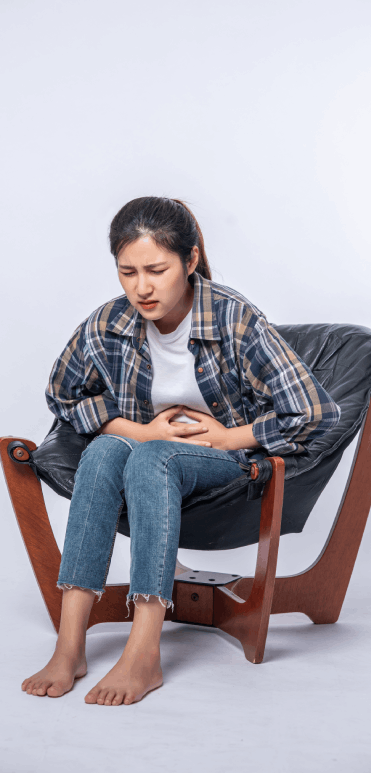 woman-sitting-chair-with-abdominal-pain-pressing-her-hand-her-stomach